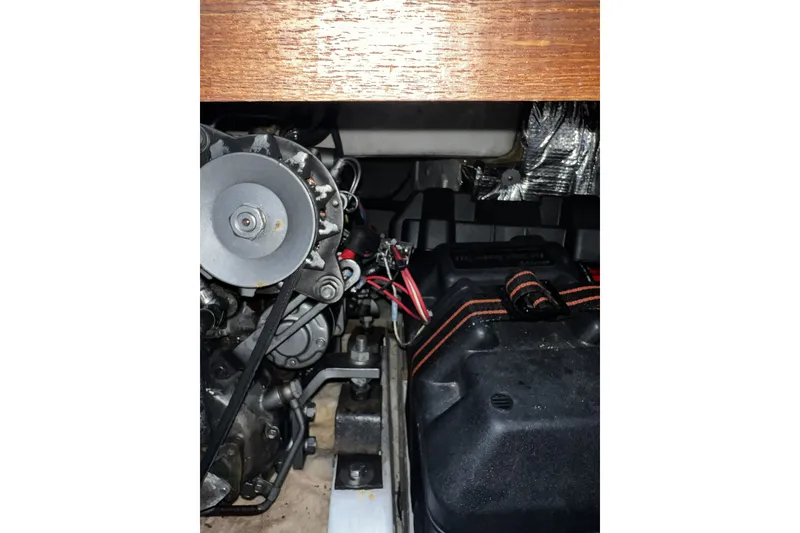 Slide: The Image of Engine compartment of a 1995 Alerion Express 28 sailboat, showing mechanical components. - 42
