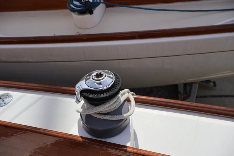 Slide: The Image of Winch on 1995 Alerion Express 28 sailboat deck with rope coiled around it. - 12