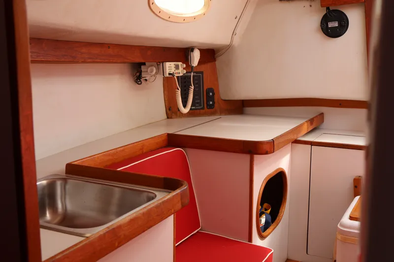 Slide: The Image of Interior of a 1995 Alerion Express 28 sailboat with sink and seating area. - 37