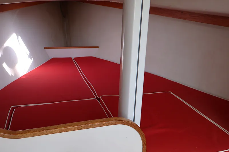 Slide: The Image of Interior cabin of 1995 Alerion Express 28 sailboat with red cushions. - 31