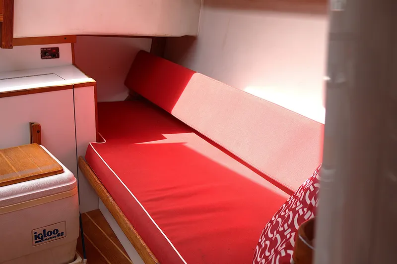 Slide: The Image of Interior of 1995 Alerion Express 28 sailboat with red cushioned seating. - 33