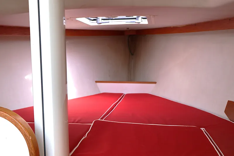Slide: The Image of Interior cabin of a 1995 Alerion Express 28 sailboat with red cushions. - 30