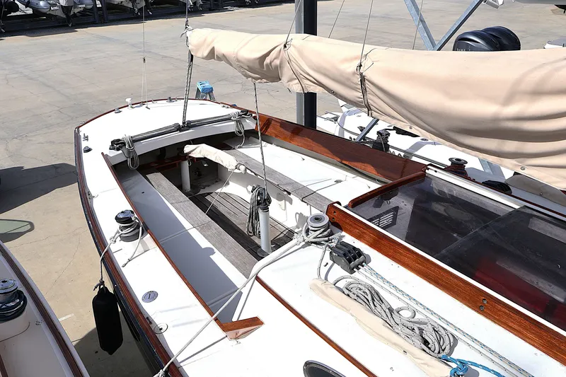 Slide: The Image of 1995 Alerion Express 28 sailboat with beige sail cover, docked on a sunny day. - 27