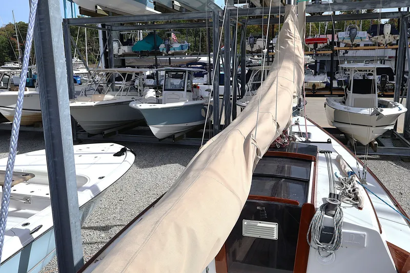 Slide: The Image of 1995 Alerion Express 28 sailboat docked among other boats in a marina. - 24