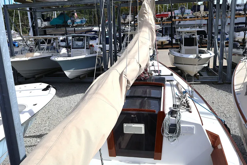 Slide: The Image of Alerion Express 28 sailboat from 1995 docked among other boats in a marina. - 23
