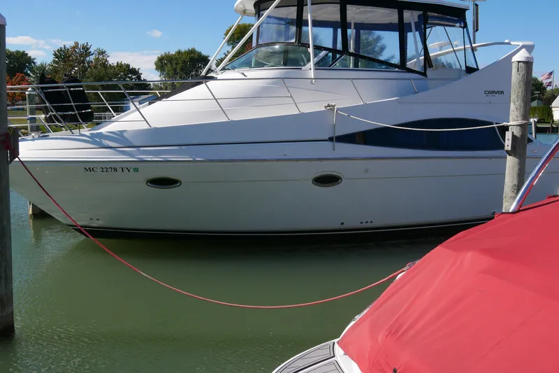 Slide: The Image of 2005 Carver 360 Mariner yacht docked in a marina, side view. - 2