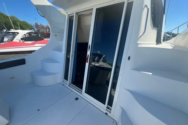 Slide: The Image of 2005 Carver 360 Mariner yacht with sliding glass doors and exterior steps. - 63