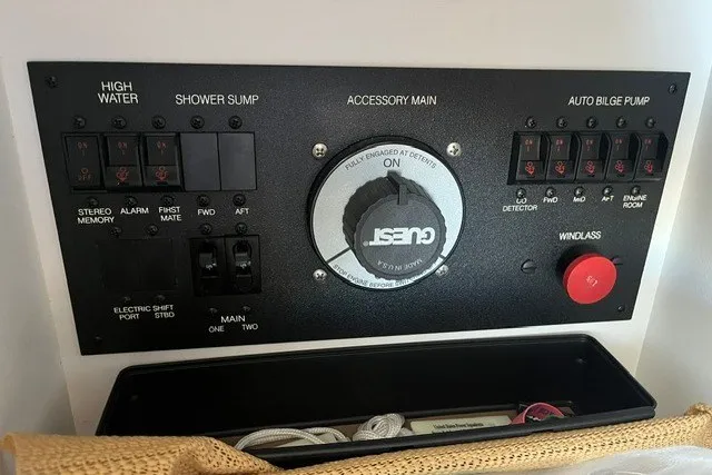 Slide: The Image of Control panel of a 2005 Carver 360 Mariner boat with various switches and dials. - 59
