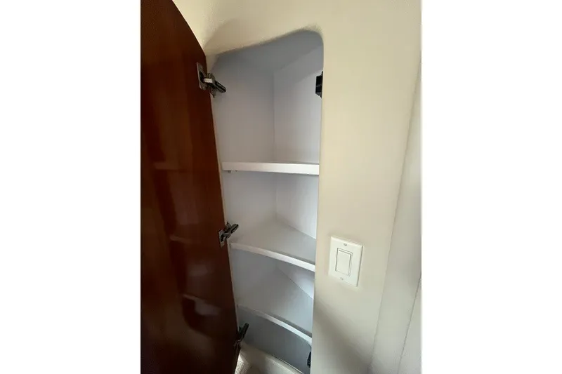 Slide: The Image of Empty storage cabinet inside a 2005 Carver 360 Mariner boat. - 57