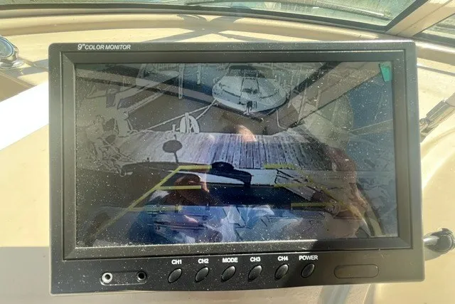 Slide: The Image of 9-inch monitor displaying a docked boat view from a 2005 Carver 360 Mariner. - 23