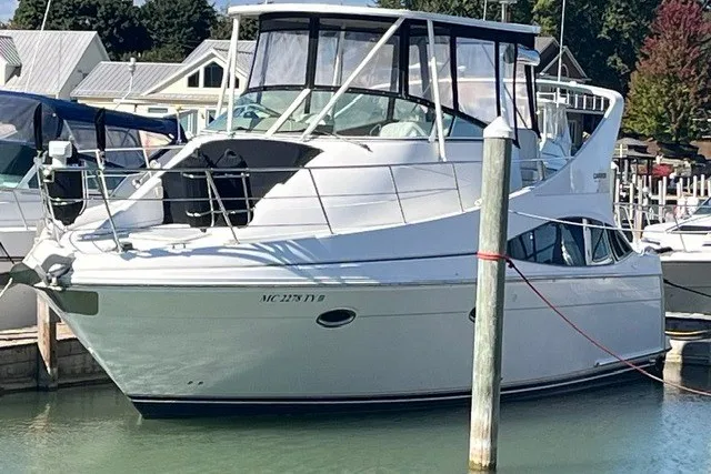 Slide: The Image of 2005 Carver 360 Mariner yacht docked at a marina, featuring sleek design and spacious cabin. - 1