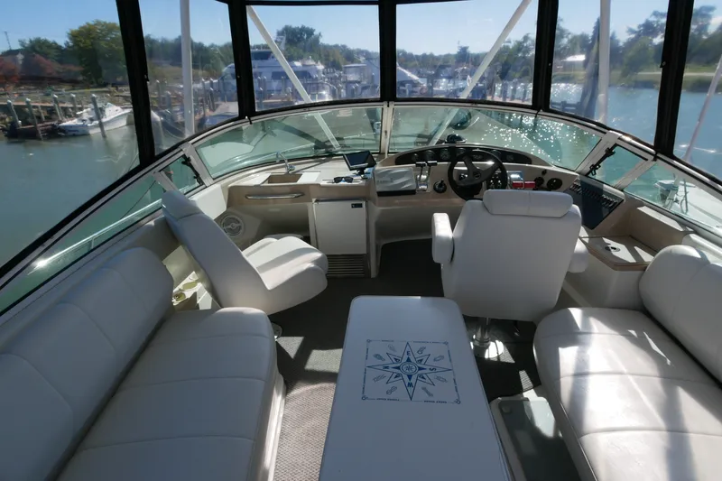 Slide: The Image of Interior view of a 2005 Carver 360 Mariner yacht with plush seating and helm. - 14