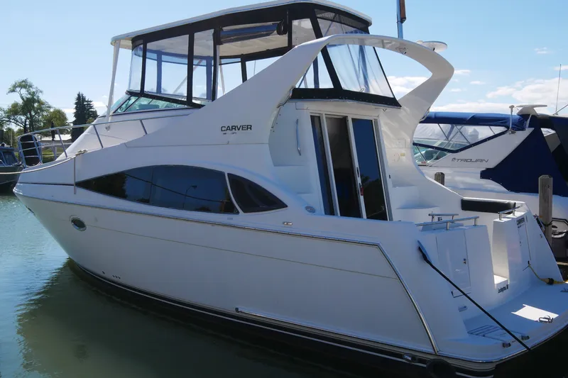 The Image of 2005 Carver 360 Mariner yacht docked in a marina under clear skies. - 0
