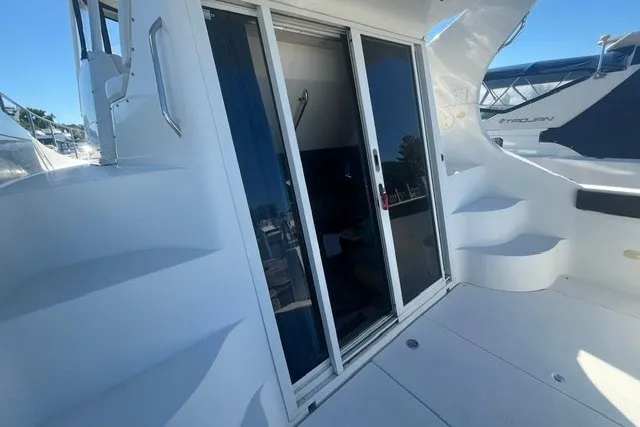 Slide: The Image of 2005 Carver 360 Mariner yacht with sliding glass doors and exterior steps. - 64