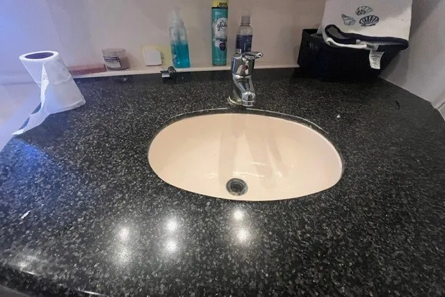 Slide: The Image of Bathroom sink with granite countertop on a 2005 Carver 360 Mariner yacht. - 49