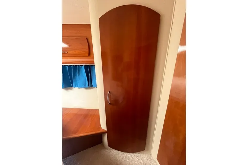 Slide: The Image of Interior of 2005 Carver 360 Mariner with wooden door and blue curtains. - 54