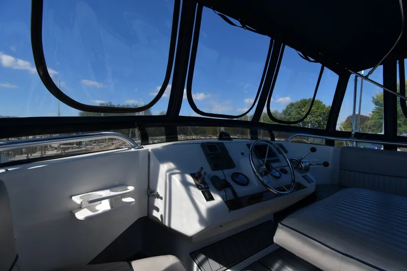 Slide: The Image of 2000 Mainship 390 Trawler helm with panoramic windows and modern controls. - 16