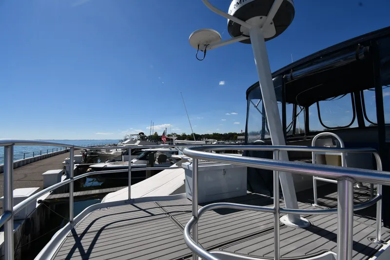 Slide: The Image of 2000 Mainship 390 Trawler docked at marina under clear blue sky. - 14