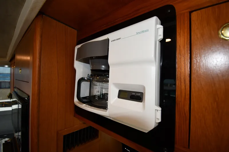 Slide: The Image of Built-in coffee maker on 2000 Mainship 390 Trawler, wooden cabinetry background. - 54