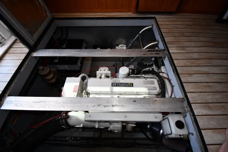 Slide: The Image of Engine compartment of a 2000 Mainship 390 Trawler, featuring a Caterpillar engine. - 57