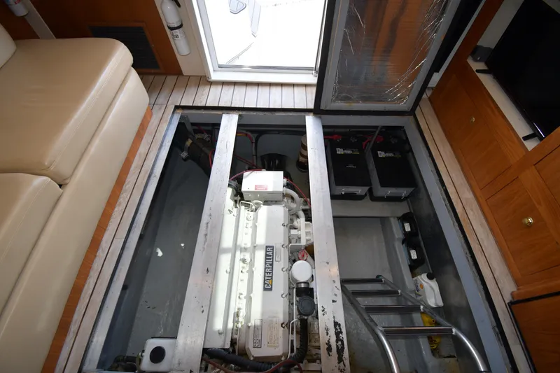 Slide: The Image of Engine compartment of 2000 Mainship 390 Trawler with Caterpillar engine and batteries. - 56
