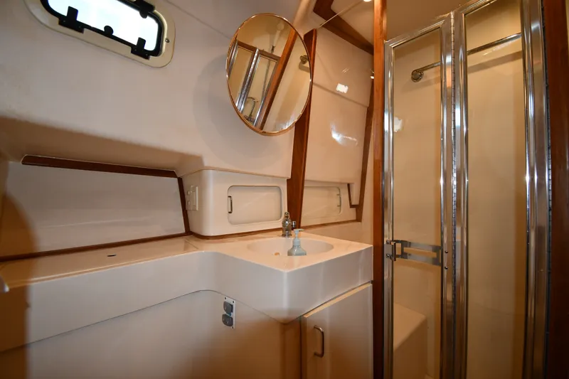 Slide: The Image of Bathroom interior of 2000 Mainship 390 Trawler with sink, mirror, and shower. - 32