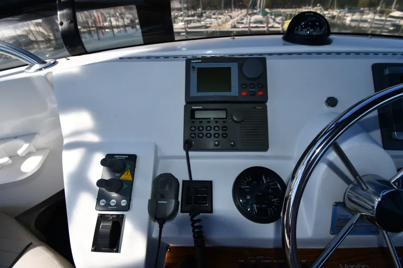Slide: The Image of Helm of 2000 Mainship 390 Trawler with navigation equipment and steering wheel. - 19