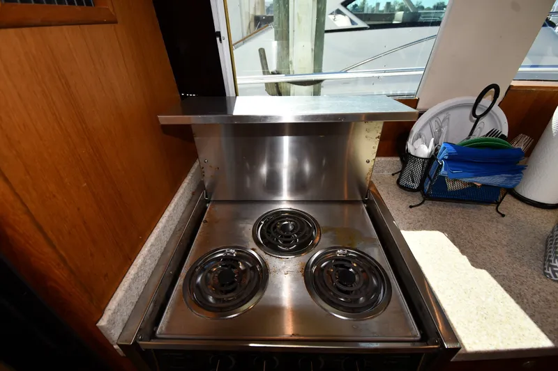 Slide: The Image of Stove in 2000 Mainship 390 Trawler kitchen with countertop and window view. - 42