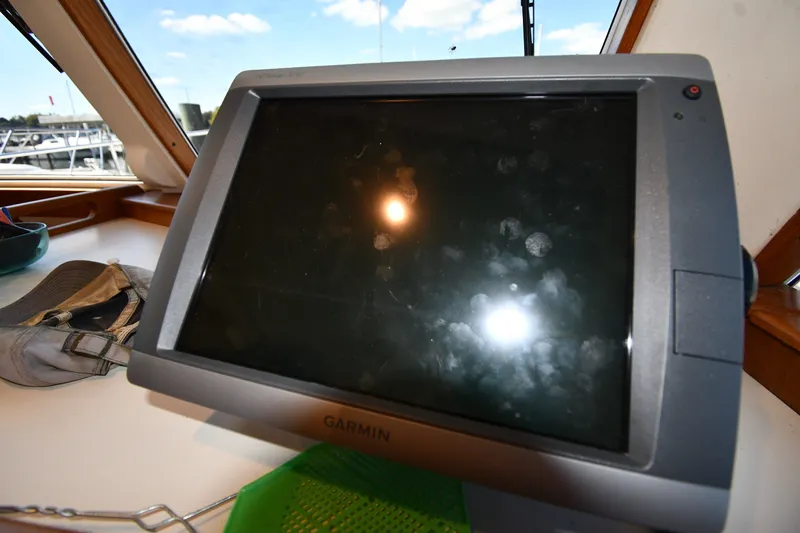 Slide: The Image of Garmin navigation system on 2000 Mainship 390 Trawler boat dashboard. - 49