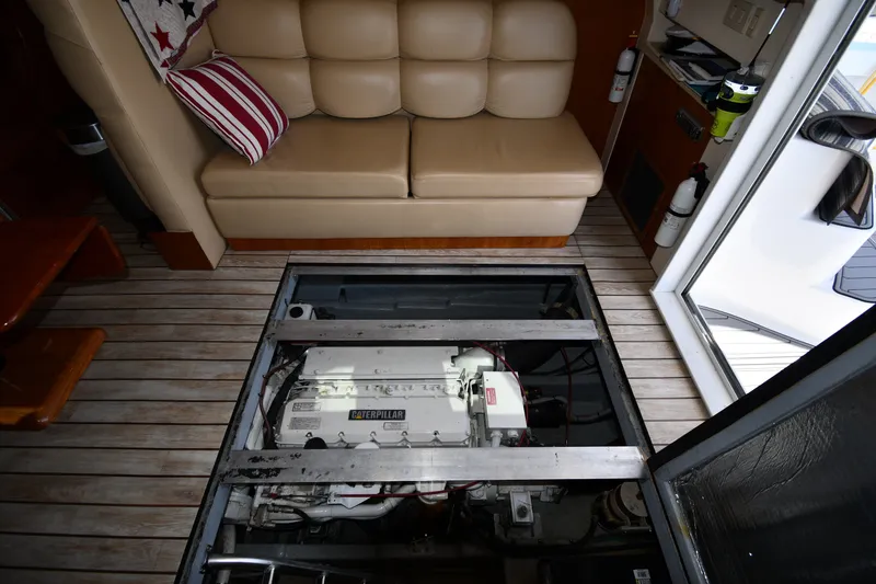 Slide: The Image of Engine compartment of 2000 Mainship 390 Trawler with Caterpillar engine, beneath cabin seating. - 55