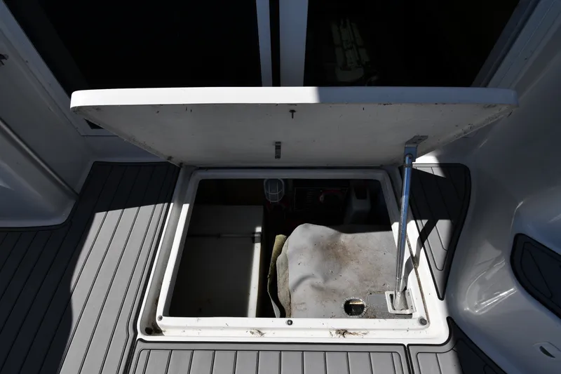 Slide: The Image of Open hatch on 2000 Mainship 390 Trawler, revealing storage compartment. - 60