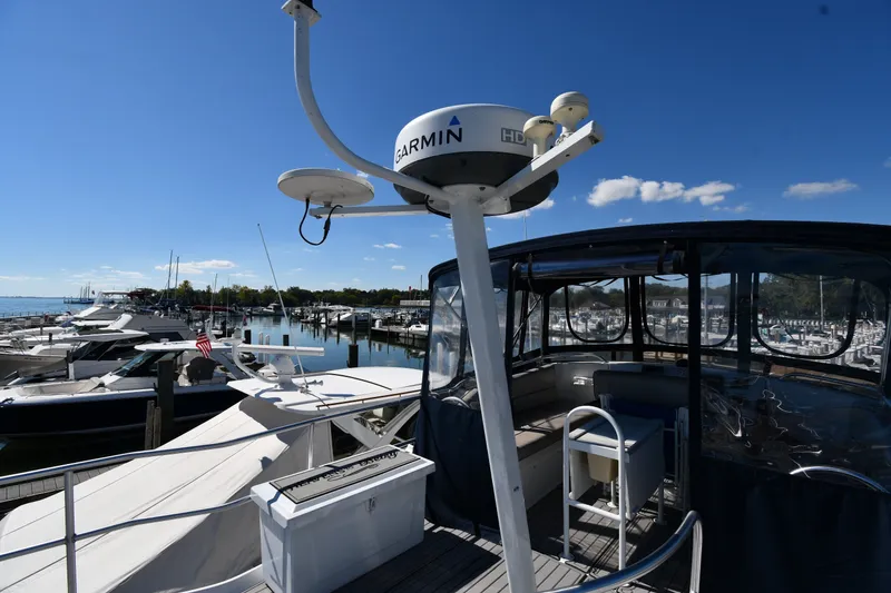 Slide: The Image of Mainship 390 Trawler 2000 docked at marina with Garmin radar, clear blue sky. - 15