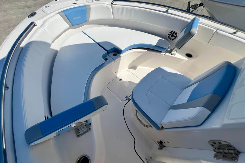 Slide: The Image of 2024 Robalo R222 Center Console boat interior with blue and white seating. - 16