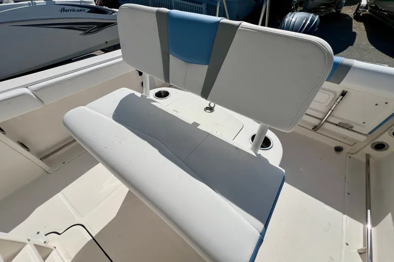 Slide: The Image of 2024 Robalo R222 Center Console boat interior with cushioned seating and storage. - 14