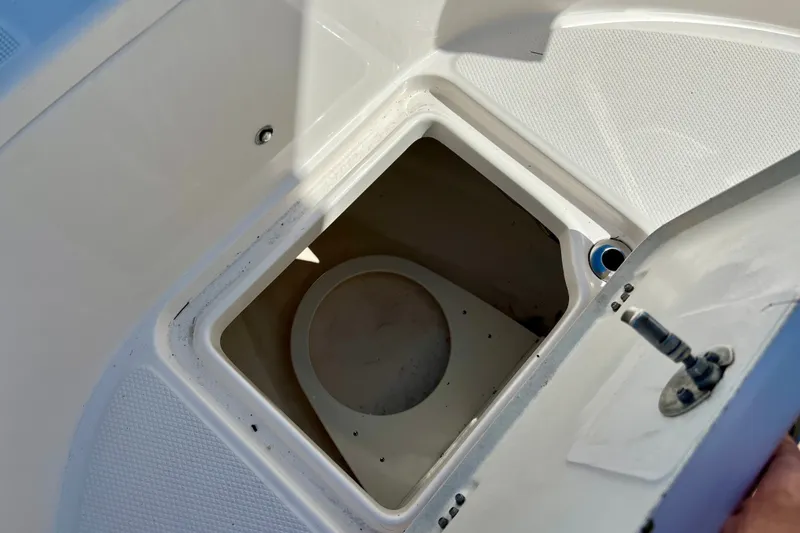 Slide: The Image of 2024 Robalo R222 Center Console boat storage compartment with open hatch. - 19