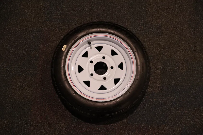 Slide: The Image of 2019 Polar Kraft Outlander 156 T spare tire on dark textured surface. - 30