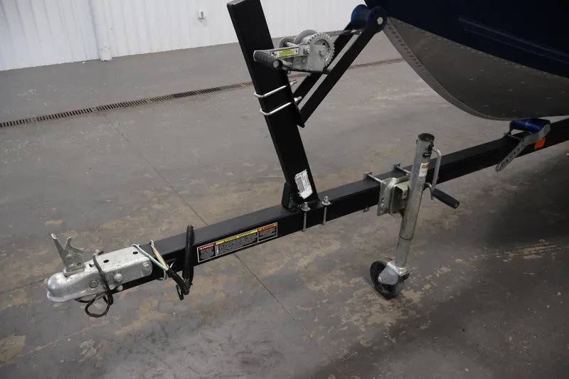 Slide: The Image of Trailer hitch of a 2019 Polar Kraft Outlander 156 T boat in a garage setting. - 27
