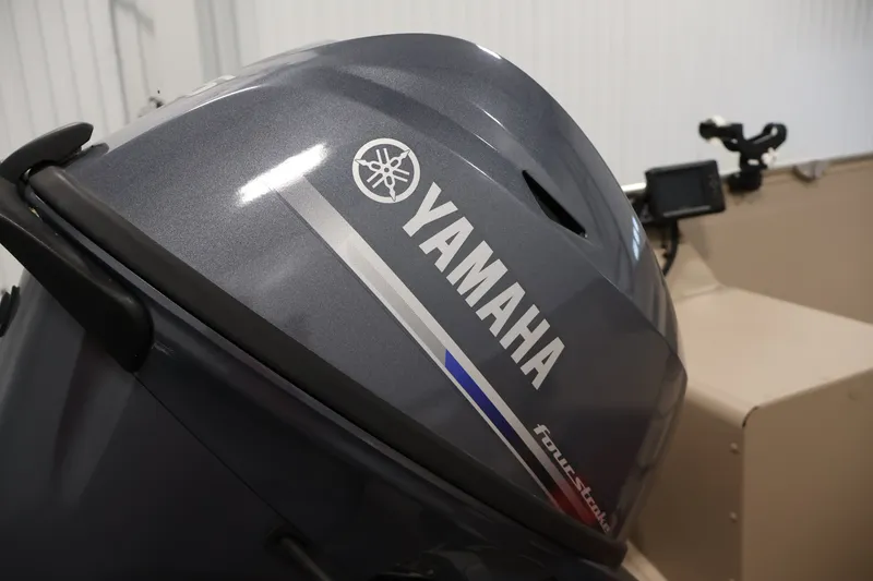 Slide: The Image of 2019 Polar Kraft Outlander 156 T with Yamaha four-stroke outboard motor in a garage setting. - 24