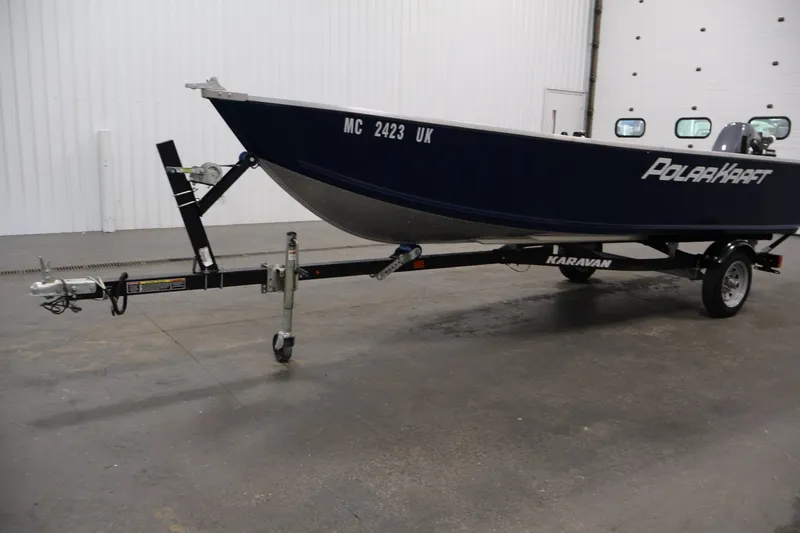 Slide: The Image of 2019 Polar Kraft Outlander 156 T boat on Karavan trailer in indoor setting. - 28