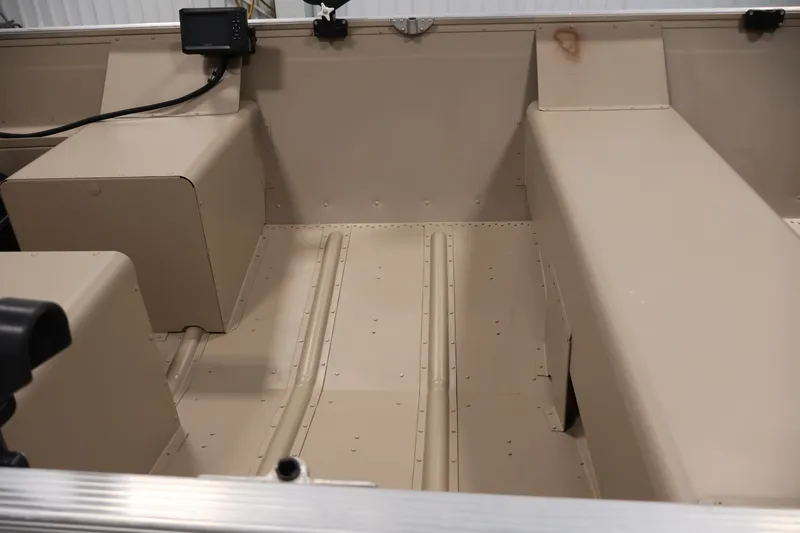 Slide: The Image of 2019 Polar Kraft Outlander 156 T interior, showcasing beige seating and storage compartments. - 16