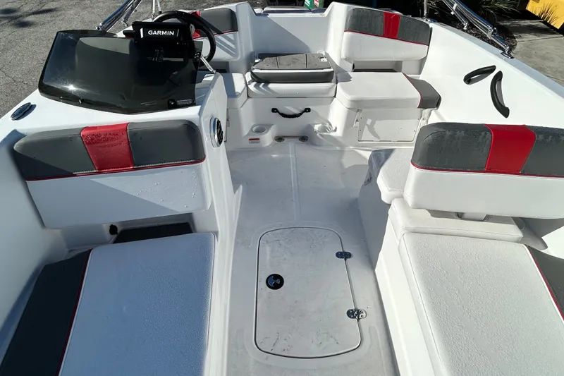 Slide: The Image of 2024 Tahoe T18 boat interior with seating, Garmin device, and storage compartments. - 13