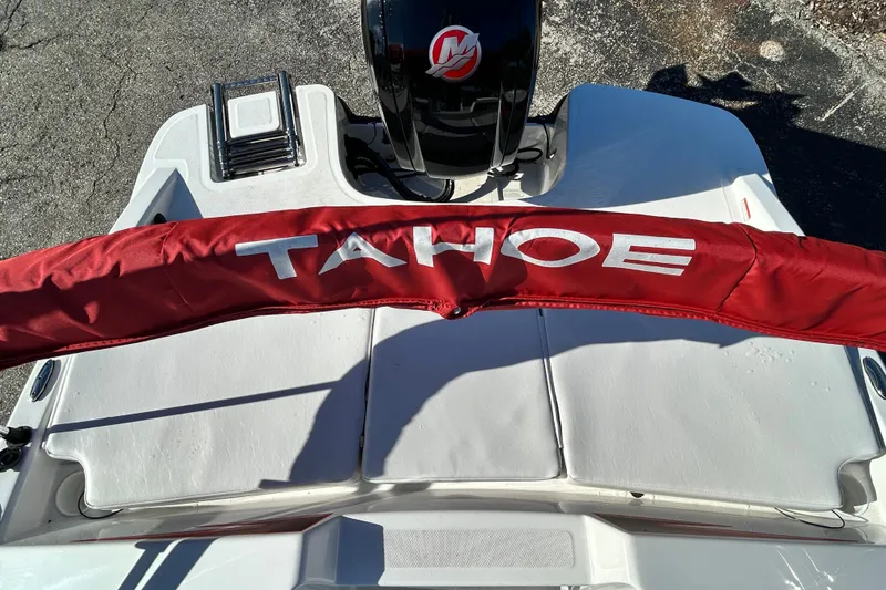 Slide: The Image of 2024 Tahoe T18 boat with red cover and Mercury engine. - 14