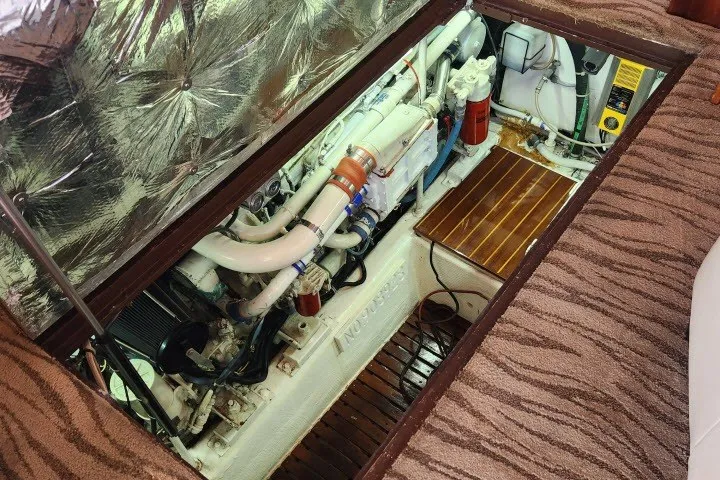 Slide: The Image of Engine compartment of a 1987 Ocean Yachts 48 Super Sport, showcasing mechanical components and insulation. - 64