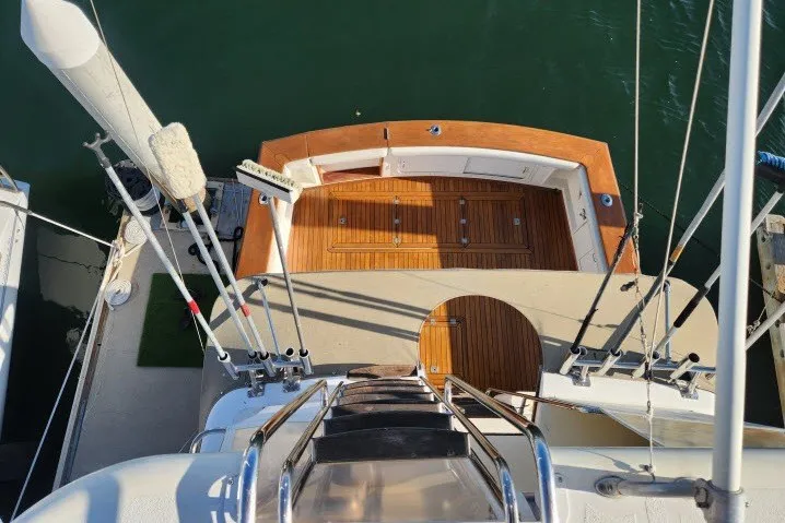 Slide: The Image of Aerial view of 1987 Ocean Yachts 48 Super Sport deck, featuring wooden flooring and railing. - 55