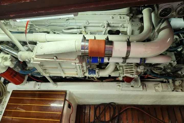 Slide: The Image of Engine room of a 1987 Ocean Yachts 48 Super Sport, showcasing mechanical components and piping. - 65