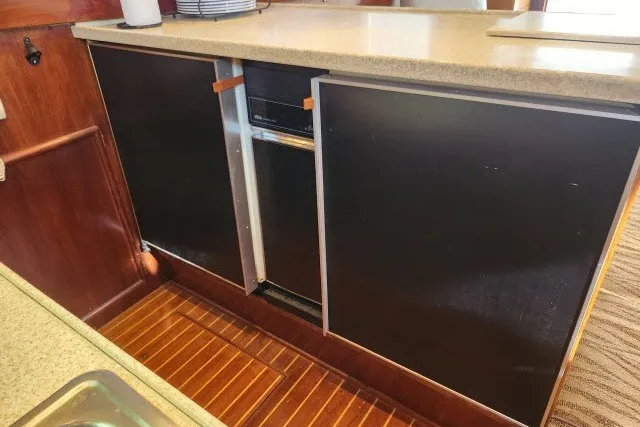 Slide: The Image of 1987 Ocean Yachts 48 Super Sport galley with wood flooring and modern cabinetry. - 17
