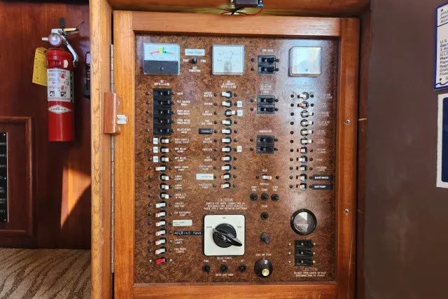 Slide: The Image of Electrical panel of a 1987 Ocean Yachts 48 Super Sport boat with switches and gauges. - 38