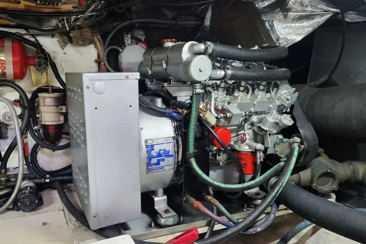 Slide: The Image of Engine room of a 1987 Ocean Yachts 48 Super Sport, showcasing mechanical components. - 67