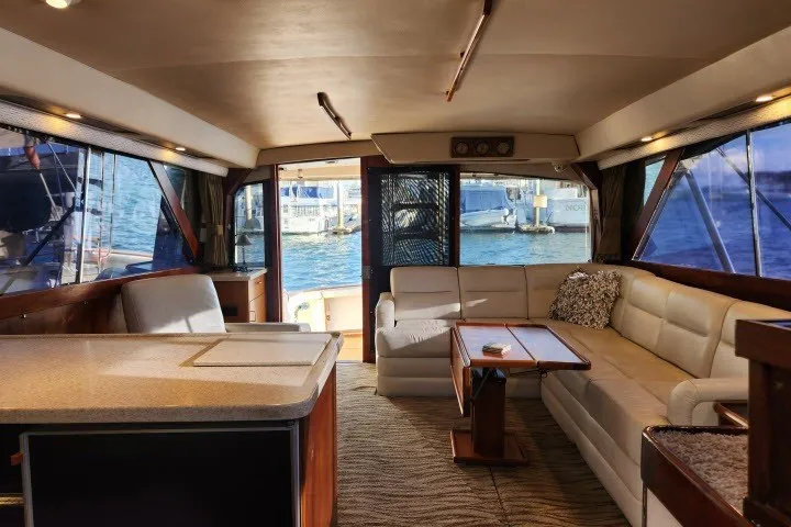 Slide: The Image of Interior of 1987 Ocean Yachts 48 Super Sport with spacious seating and marina view. - 34