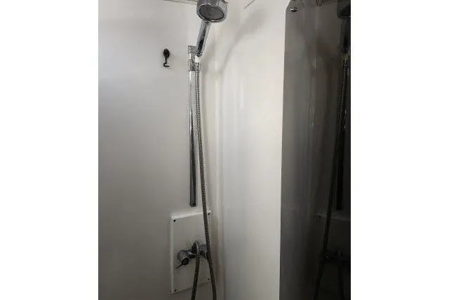 Slide: The Image of Shower area in 1987 Ocean Yachts 48 Super Sport boat, featuring a handheld showerhead. - 27